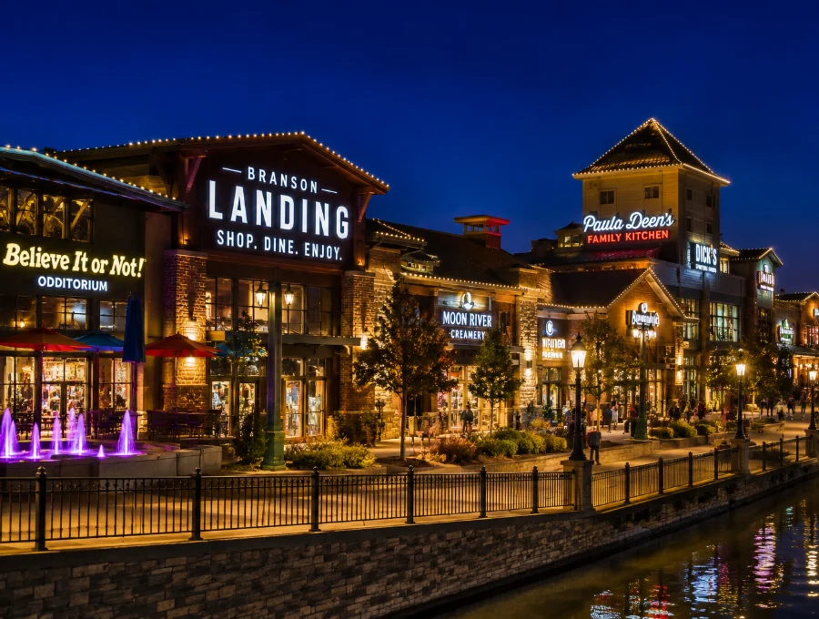 Shoppers walking the Branson Landing boardwalk past waterfront stores