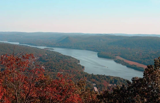 Lake winding through hills covered in fall foliage