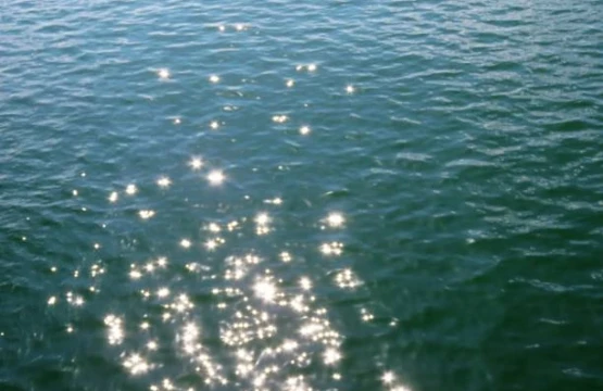 Sunlight sparkling on blue-green lake water