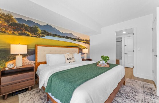 Cozy king bedroom with golf course mural, green throw and nightstand lamps